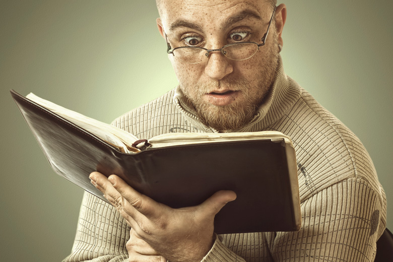 Confused man reading book