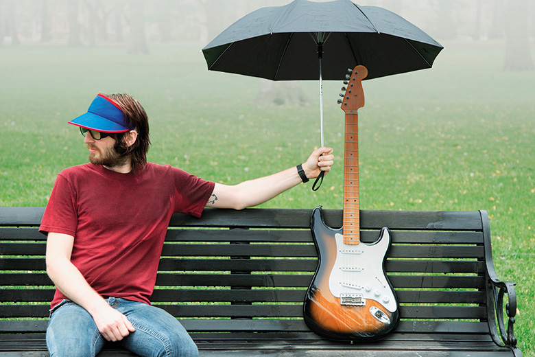 Covering a guitar with an umbrella
