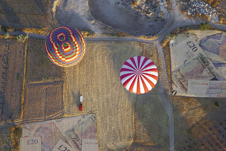 Hot air balloons above a field