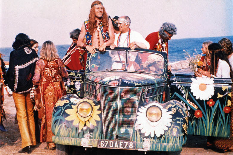 Group of hippies gathered around car