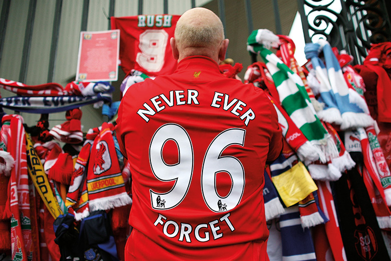 Liverpool F.C. football fan pays respects at Hillsborough memorial, Anfield
