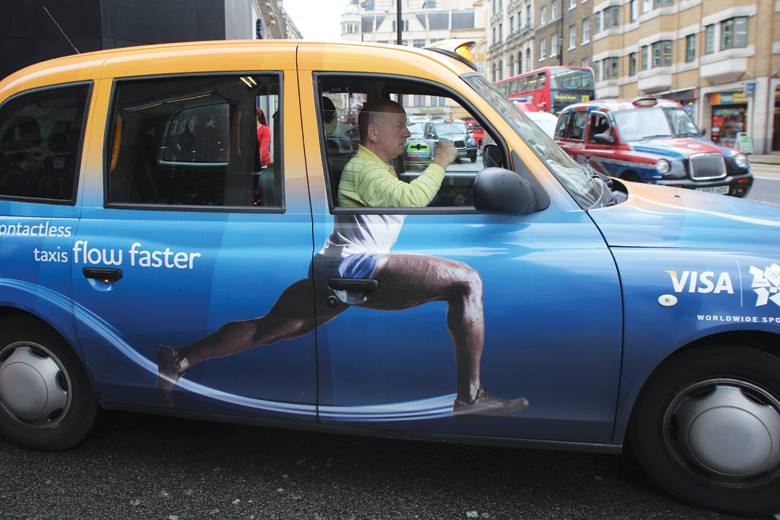 London taxi cab driver pulling into traffic