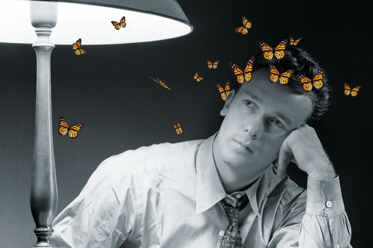 Man in thought surrounded by butterflies