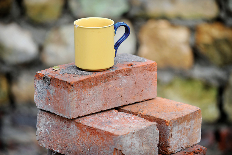 Mug on pile of bricks