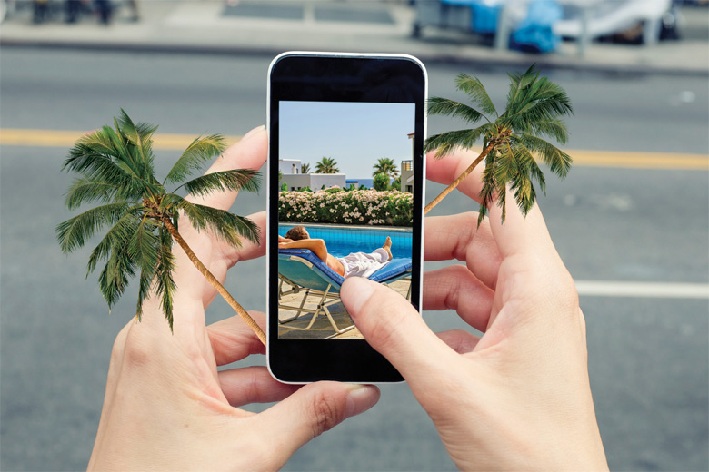 Person browsing holiday photos on smartphone screen