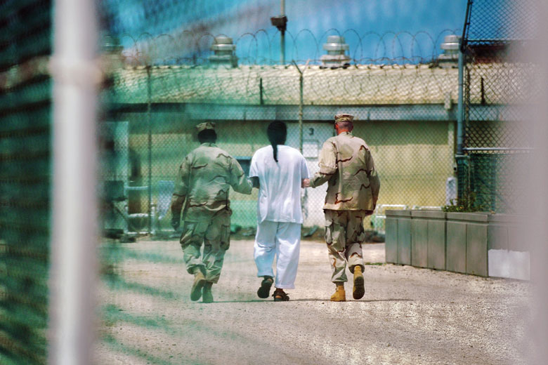 Prisoner being led by guards, Guantanamo Bay