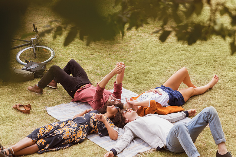 Students lying on the grass in a park