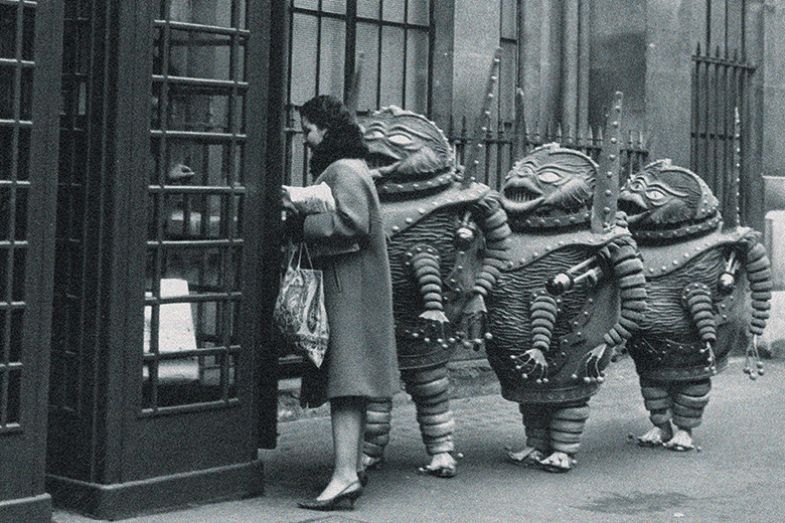 Aliens queuing outside a phone box