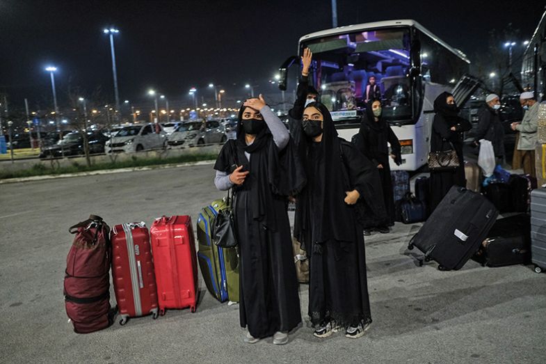 Afghan refugees board buses bound for temporary housing after arriving at Thessaloniki International Airport