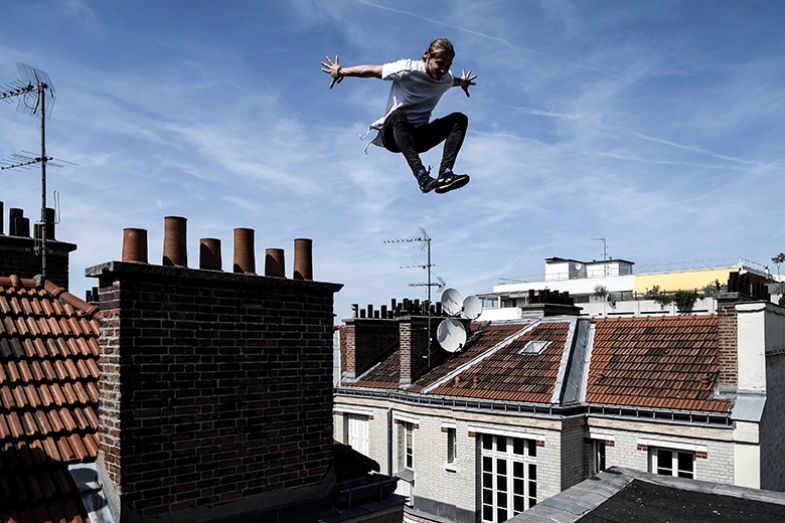 Man jumping above houses