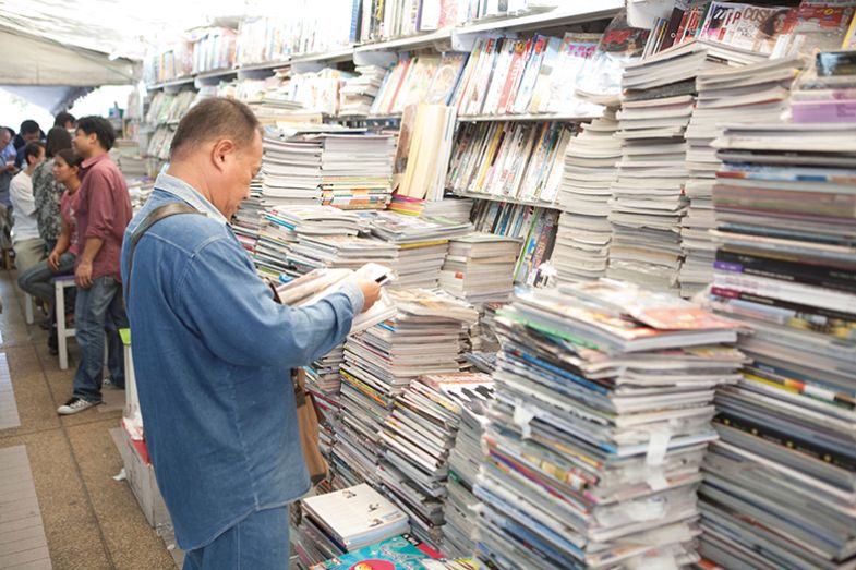 man reading magazines