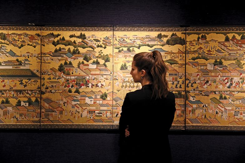 Woman looking at historic Asian painting