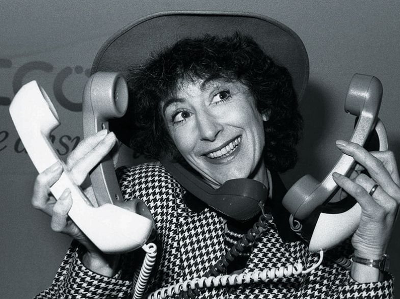 Maureen Lipman holding five telephones