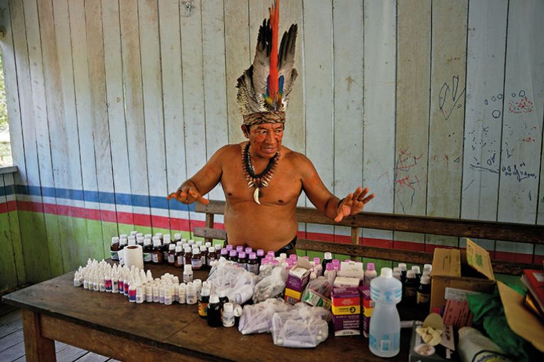 Chief Marcelino Apurina, of the Aldeia Novo Paraiso in the Western Amazon region of Brazil near Labrea, stands by a table of modern medicines delivered to the village on September 21, 2017