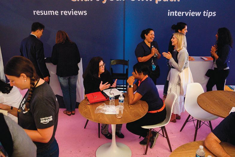 Job hunters speak with Amazon recruiters at an Amazon Career Day event