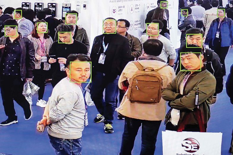 Visitors being filmed by AI security cameras with facial recognition technology at the 14th China International Exhibition on Public Safety and Security, Beijing