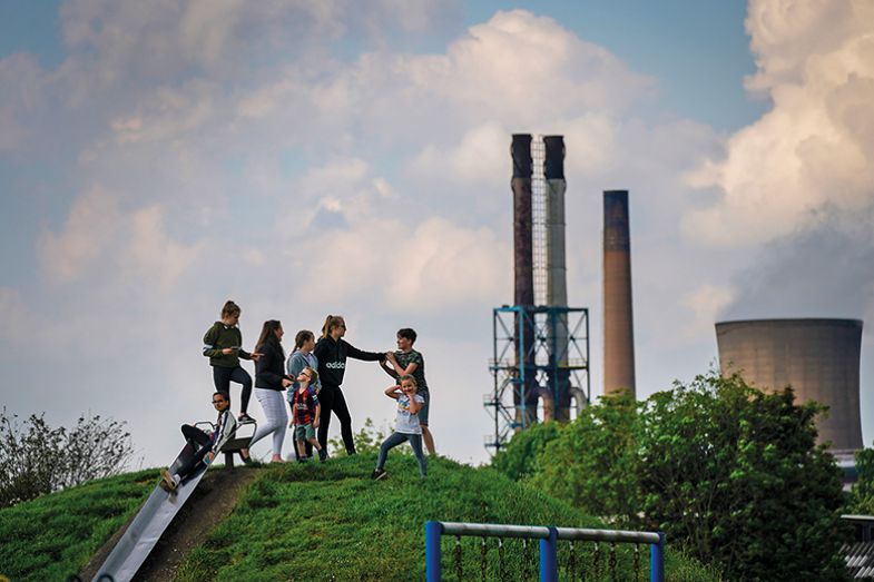 Children play in a park near British Steel’s Scunthorpe works which was forced into liquidation in 2019