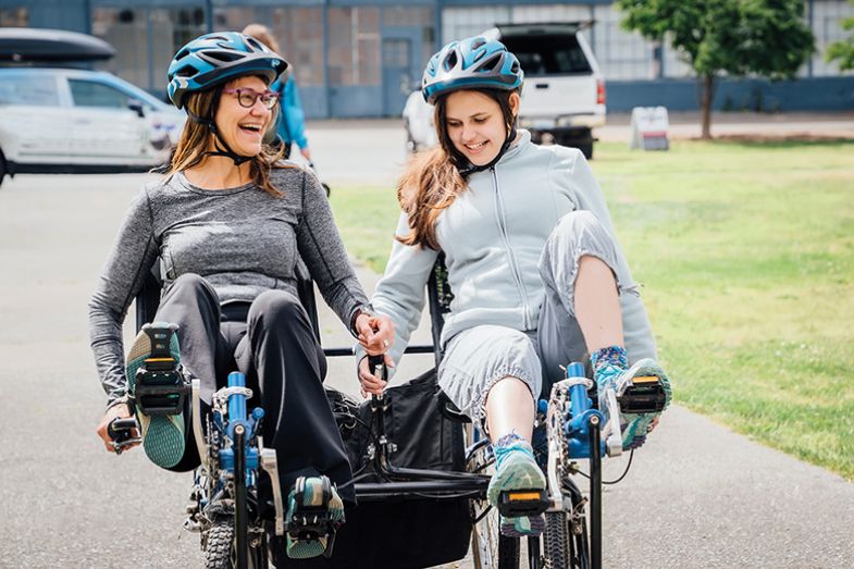 Mother and daughter on tandem bicycle