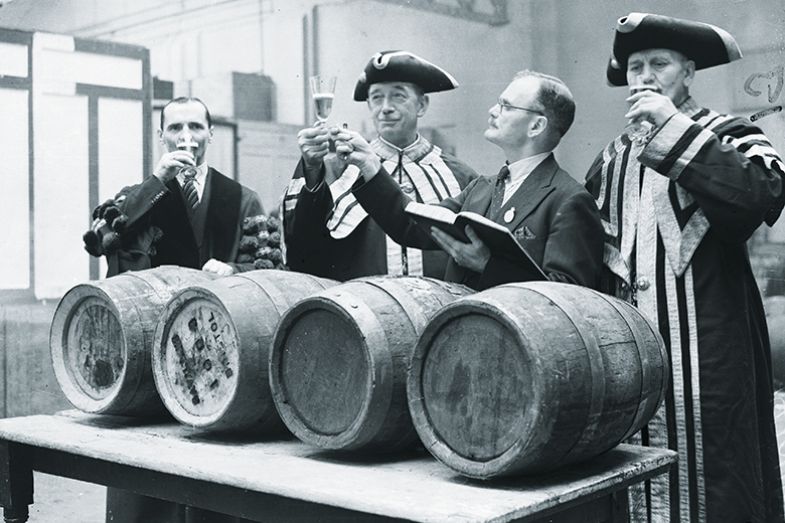 Four men tasting alcohol