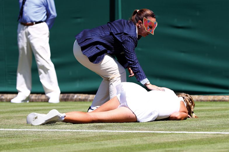 Tennis player lying face-down on the court
