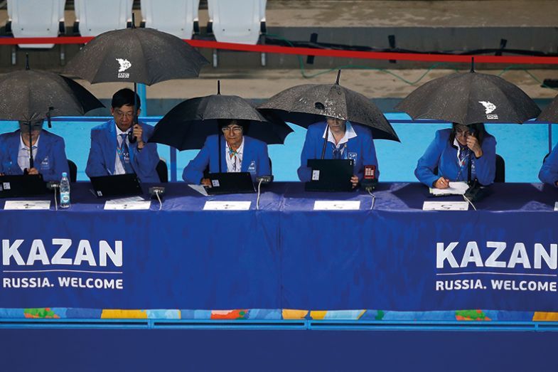 Sports judges under umbrellas