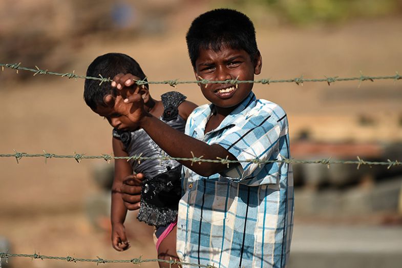 Children behind a barbed wire fence in Sri Lanka