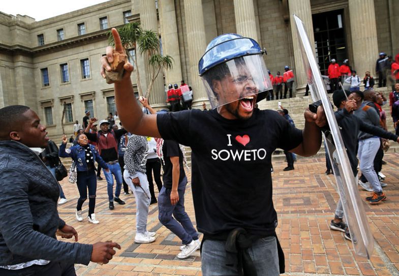  A Wits University student leader Mcebo Dlamini, wearing a security guards helmet and holding a shield