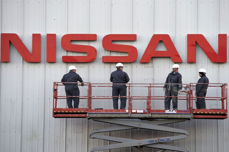Workmen prepare to clean a large Nissan sign on the exterior of their Sunderland Plant in Sunderland