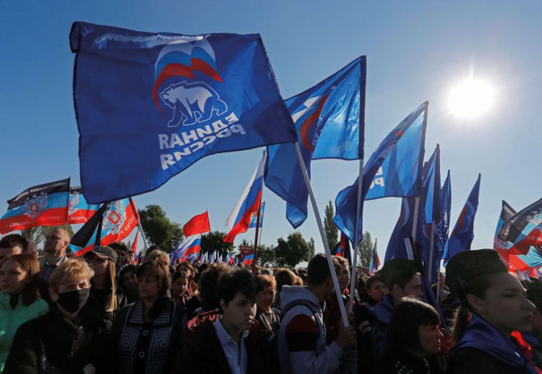  People hold flags of Russia's ruling United Russia party