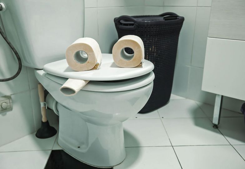 Toilet with three rolls to look like a face