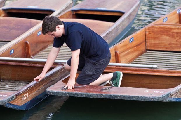 A boy working on the punts at the University of Cambridge