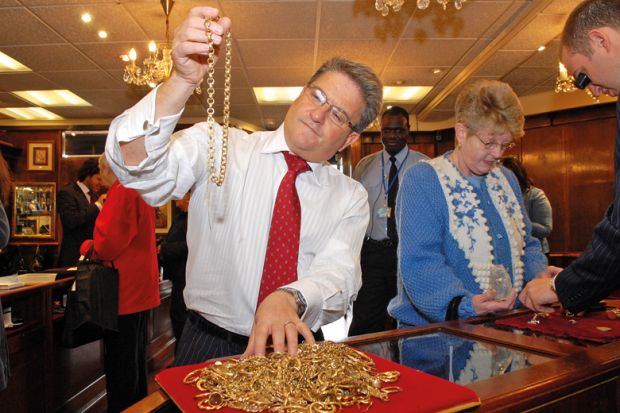A man inspecting gold jewellery