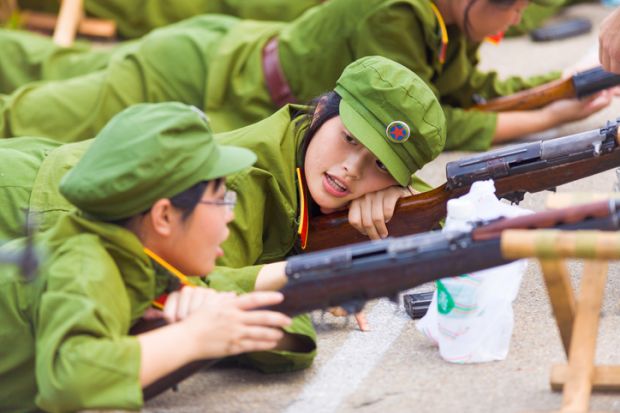 A Chinese female university student during compulsory university military training