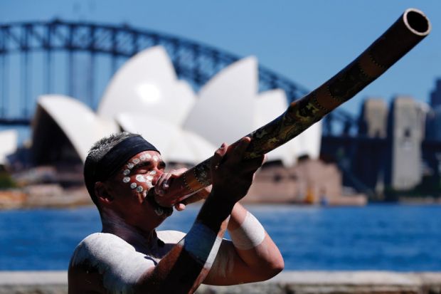 Aboriginal man plays didgeridoo, Sydney Opera House, Australia