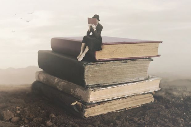 A little person on a pile of books