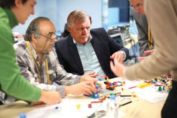 Adults playing with Lego