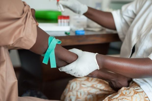 Nurse taking blood in Africa 