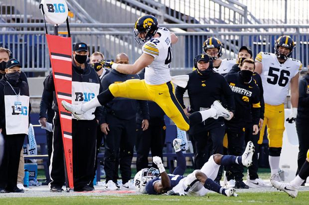 Shaun Beyer of the Iowa Hawkeyes leaps over Lamont Wade of the Penn State Nittany Lions  to illustrate Gambling threat ‘rising on US campuses’