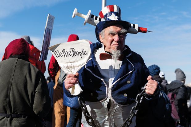 A demonstrator dressed as Uncle Sam stands for a photograph during an anti-vaccine mandate rally at the Washington Monument in Washington, D.C., U.S., on Sunday, Jan. 23, 2022.