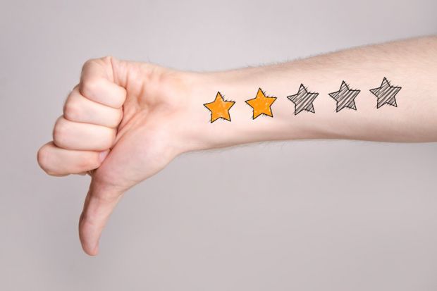 Arm with thumb down and low star rating