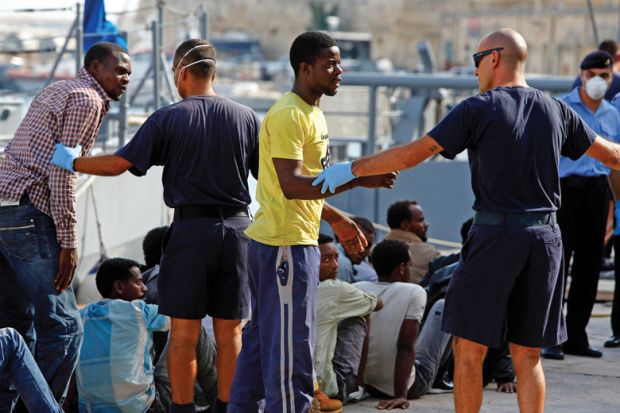 Arriving immigrants being directed on harbour side