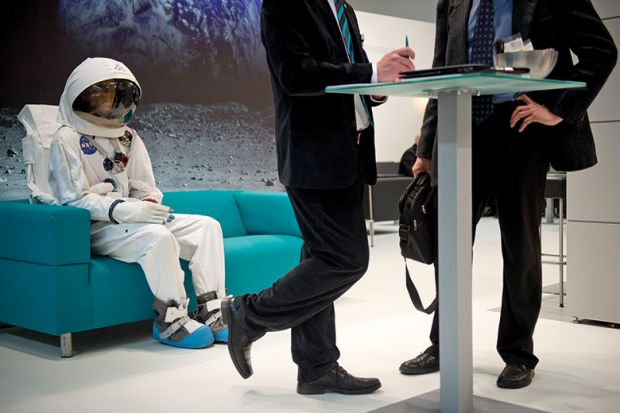 An astronaut sitting on a couch behind two business men