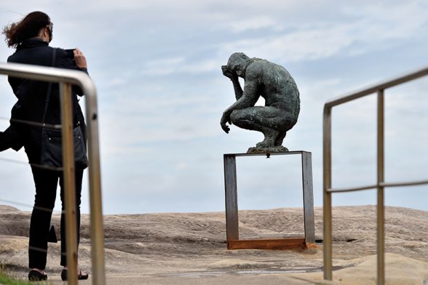 A visitor takes a picture of a sculpture by British artist Laurence Edwards at the “Sculpture by the Sea” exhibition that runs along the Bondi to Tamarama coastal walk in Sydney, 22 October 2015