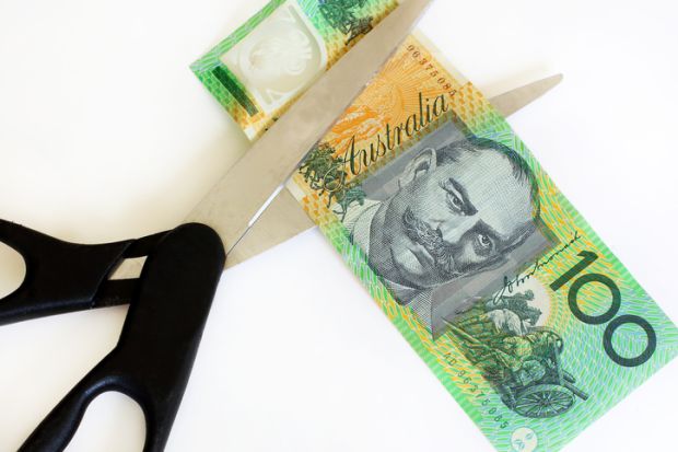 Australian dollars cut with scissors