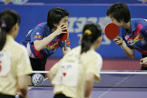 Chinese table tennis players whisper to each other