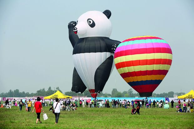 A panda-shaped hot-air balloon is displayed during the Zhengzhou Airshow to illustrate China’s tuition fee hikes ‘foreshadow’ marketised  HE system