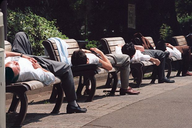 Men sleeping on benches