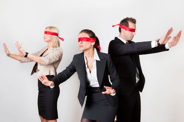 Blindfolded business people holding arms out