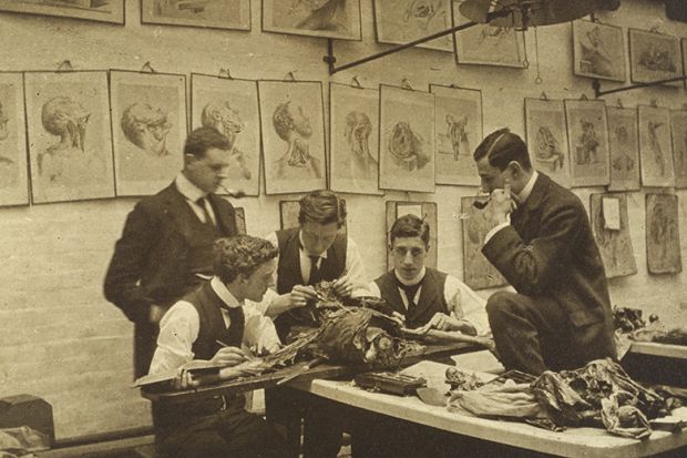 The interior of a dissecting room: five students and/or teachers dissect a cadaver