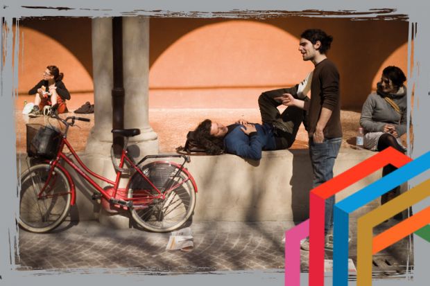 Students relax in the sunshine at the University of Bologna.